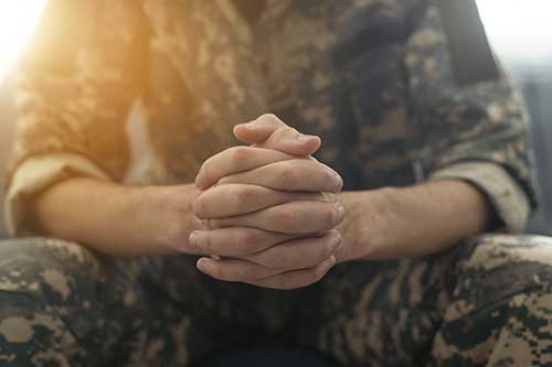 Portrait-of-middle-aged-sad,-desperate-military-man-during-therapy-session.-Disabled-soldier-suffering-from-depression-psychological-trauma.-PTSD-concept